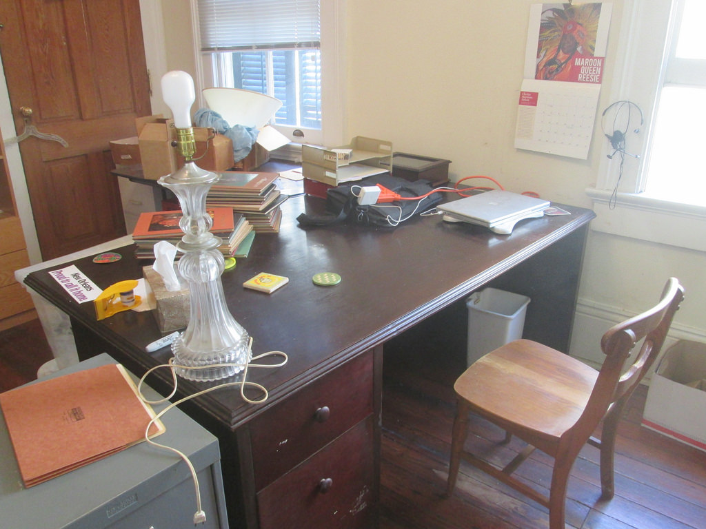 A wooden home-office desk with computer equipment